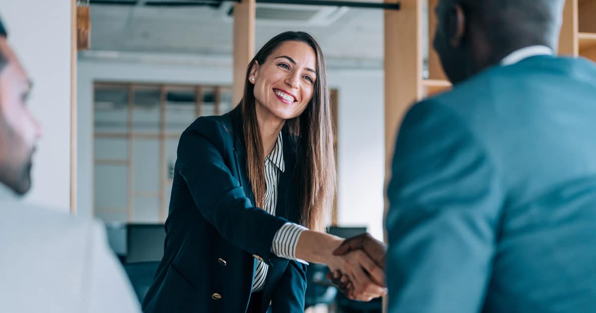 businesswoman shaking hands with interviewer